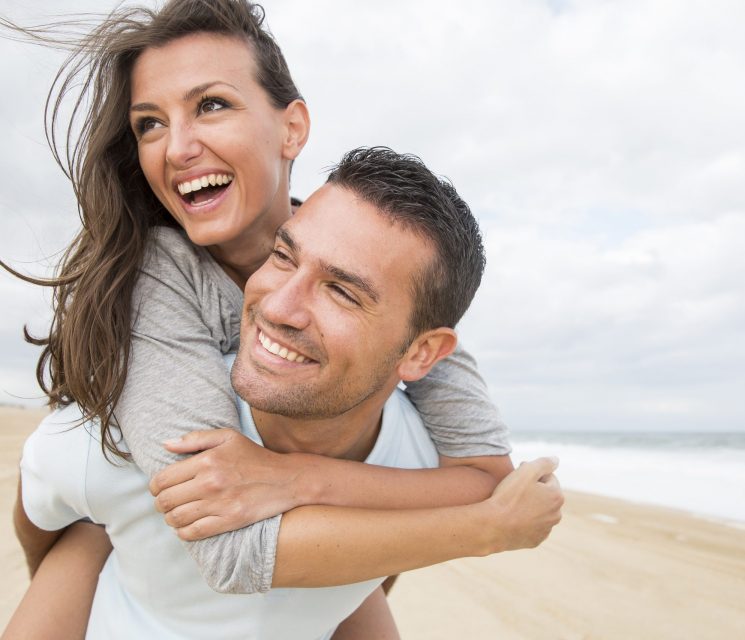 portrait of living young couple at the beach